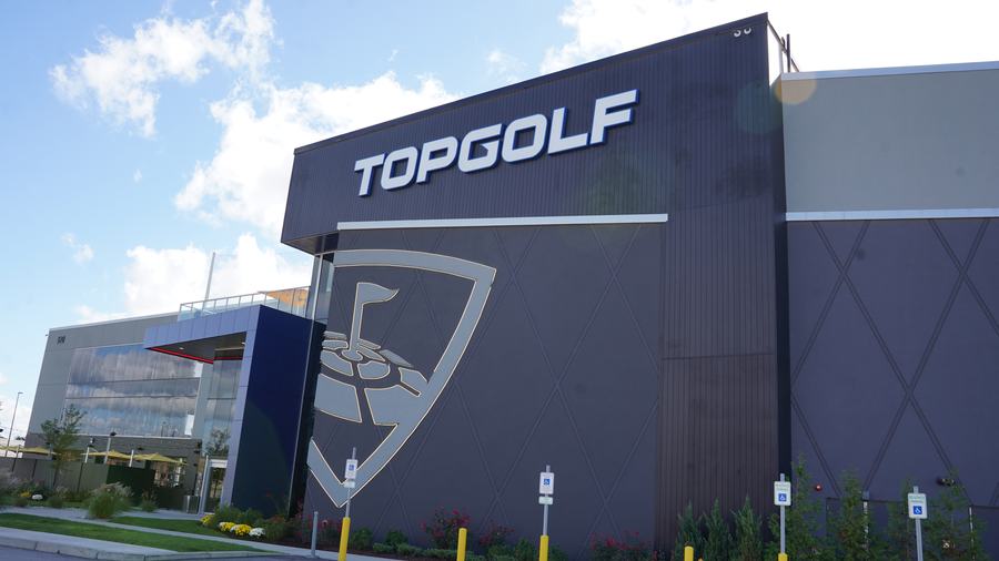 Large-format metal wall panels on a venue facade